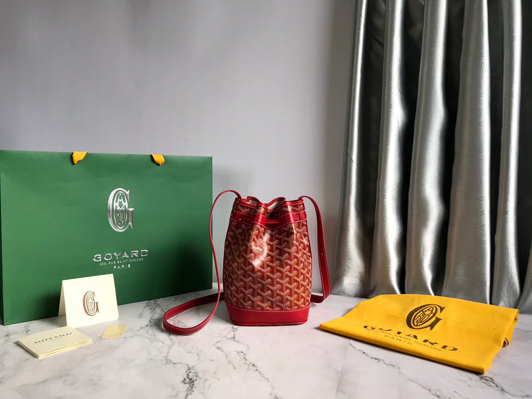 PETIT FLOT BUCKET BAG 22 IN CLASSIC RED GOYARDINE CANVAS AND LAMBSKIN TRIM Luxe Carry Bags